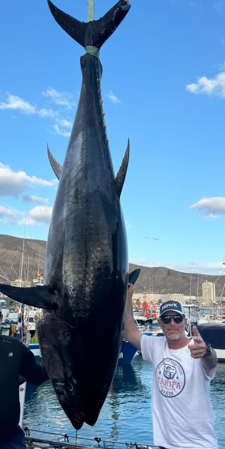 Captain Alí Alonso at the dock beside a giant bluefin tuna, Canary Islands